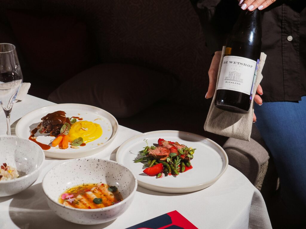 Elegant dining setup featuring gourmet dishes paired with fine wine. Ideal for culinary enthusiasts.