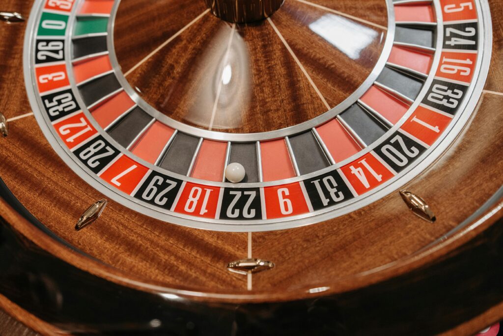 Detailed view of a roulette wheel in a casino setting, showcasing numbers and ball position.