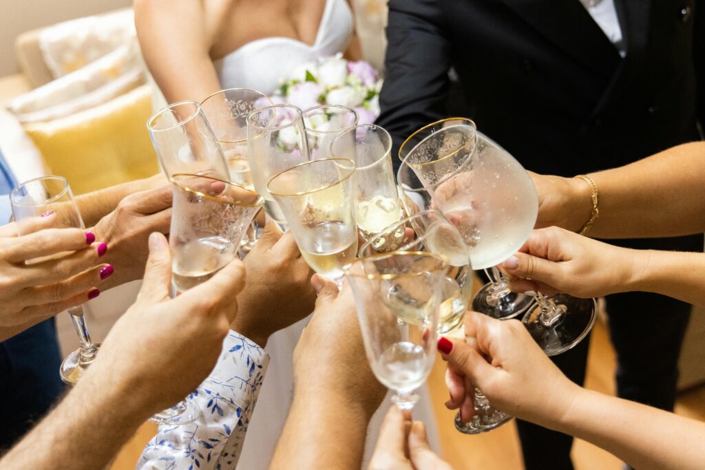 Hands toasting with champagne glasses at a wedding celebration